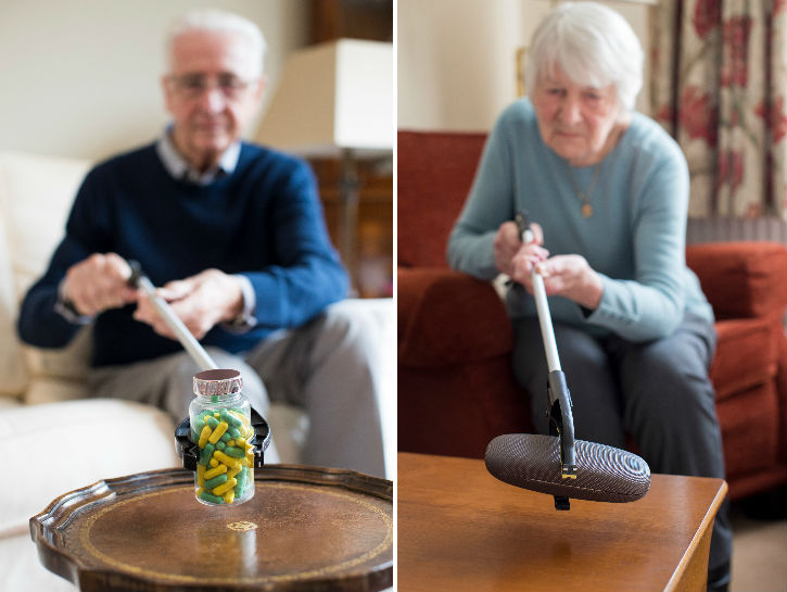 A senior man and woman using a grabber to pick up objects