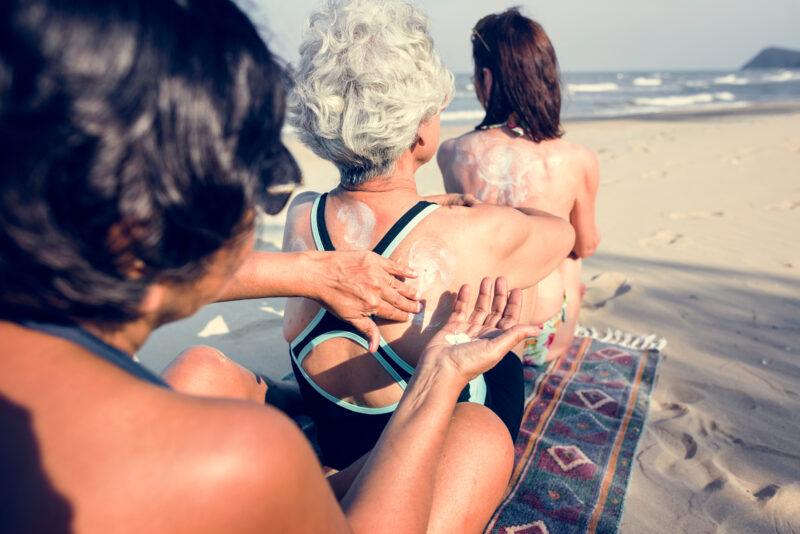 senior women applying sunscreen