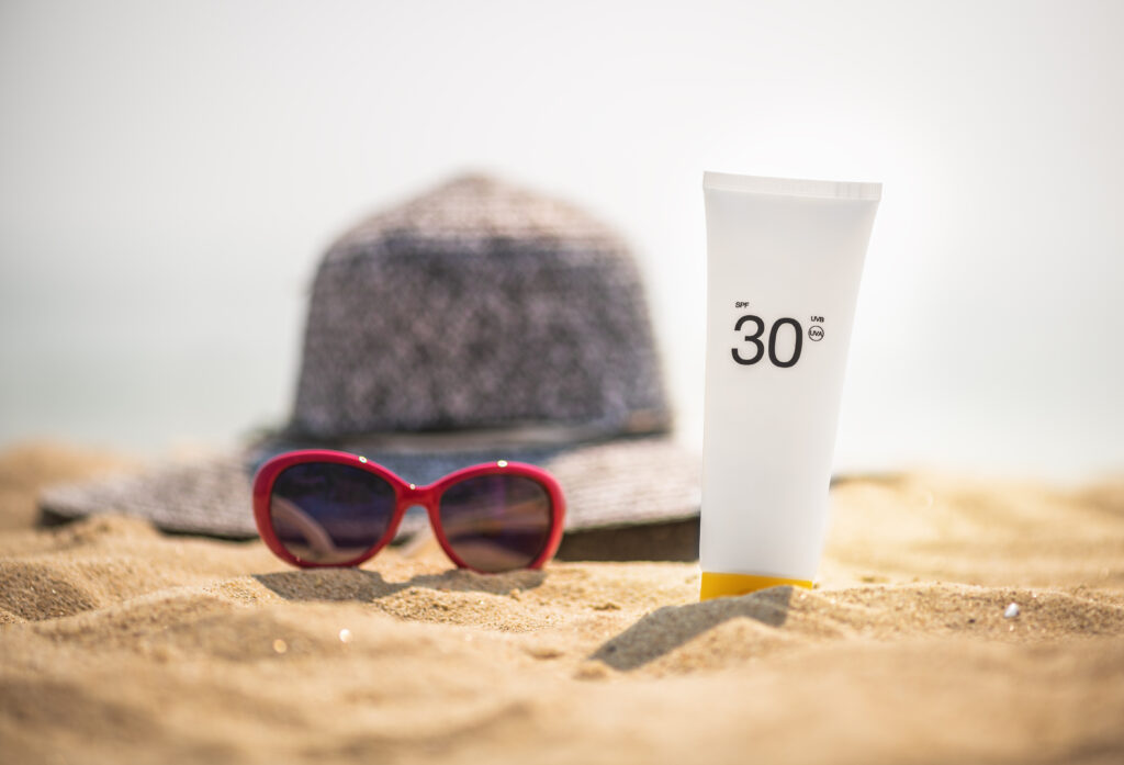 sunscreen tips, bottle on beach