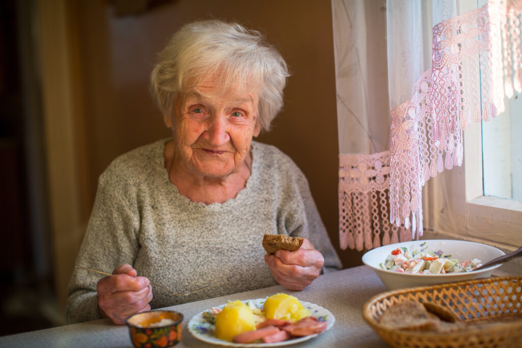 elderly woman eating meal