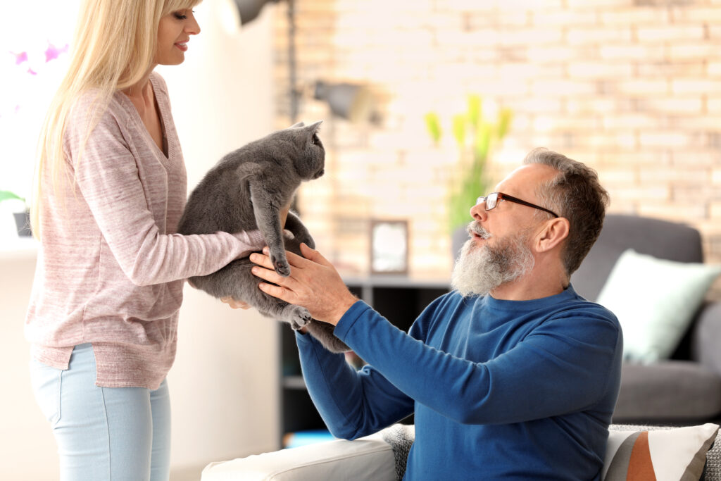 senior man with pet caregiver and cat