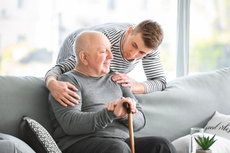 caregiver comforting senior man