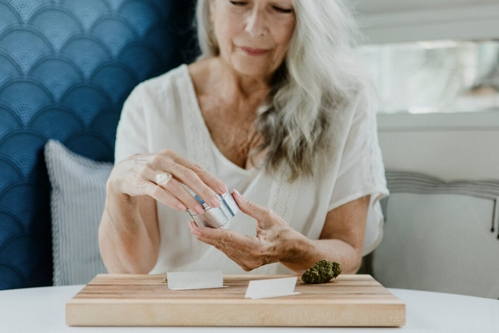 marijuana for pain in the elderly, senior woman rolling a joint