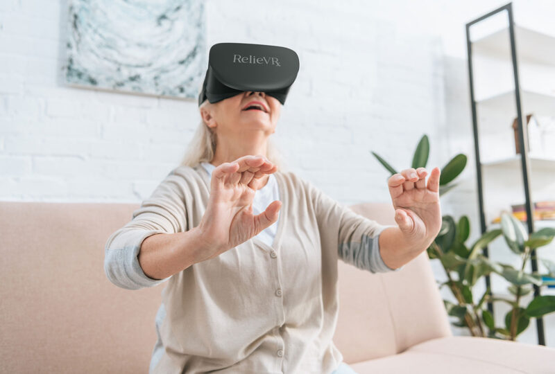 senior using relievrx for virtual pain relief