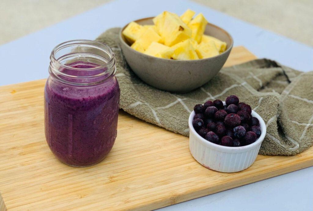 power smoothie on cutting board with fruit