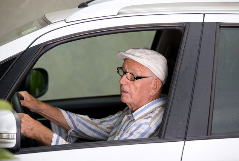 senior elderly man driving vehicle