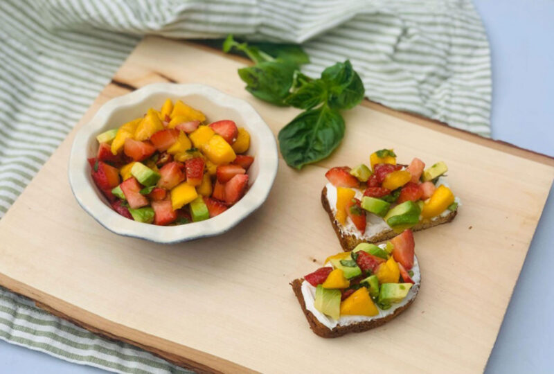 strawberry mango avocado salsa on a cutting board