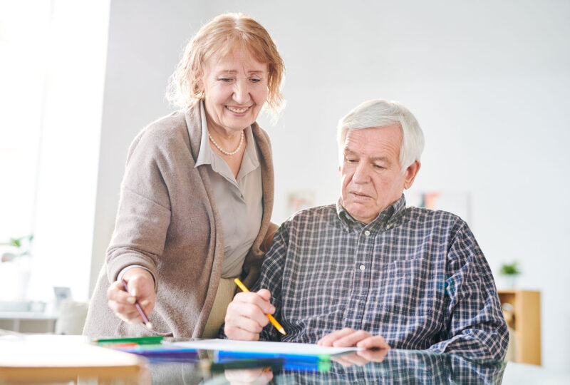 older man with pencil and older woman