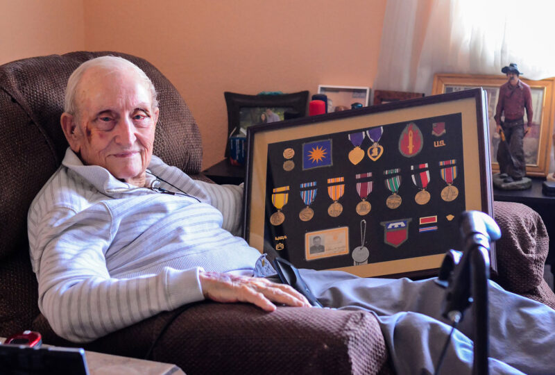 senior man veteran with framed military medals
