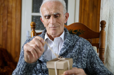 elderly man opening present