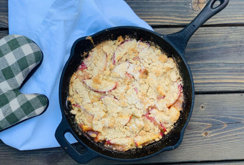 mango and peach cobbler in cast iron skillet on taable