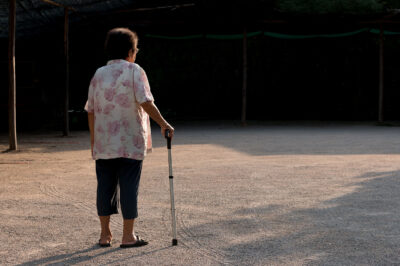 senior woman with walker standing alone