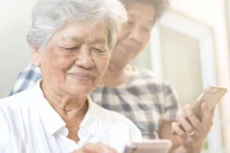 senior women holding and looking at smartphones