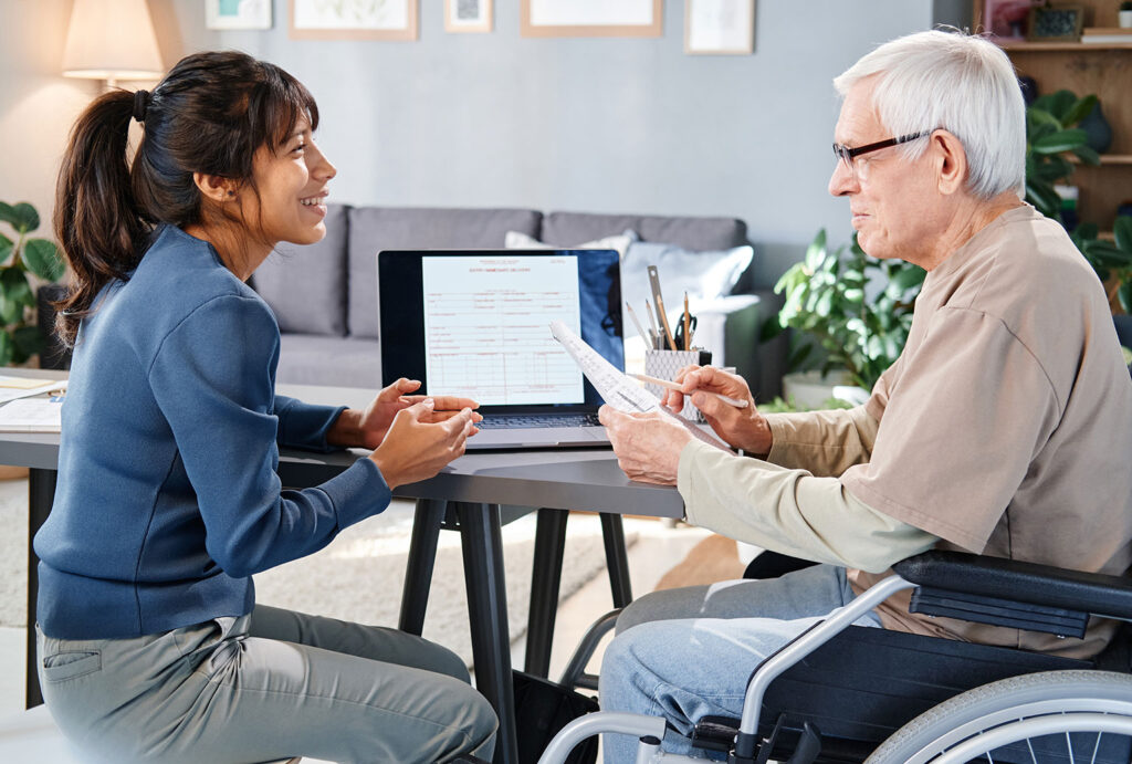 woman caregiver discussing contract with older man