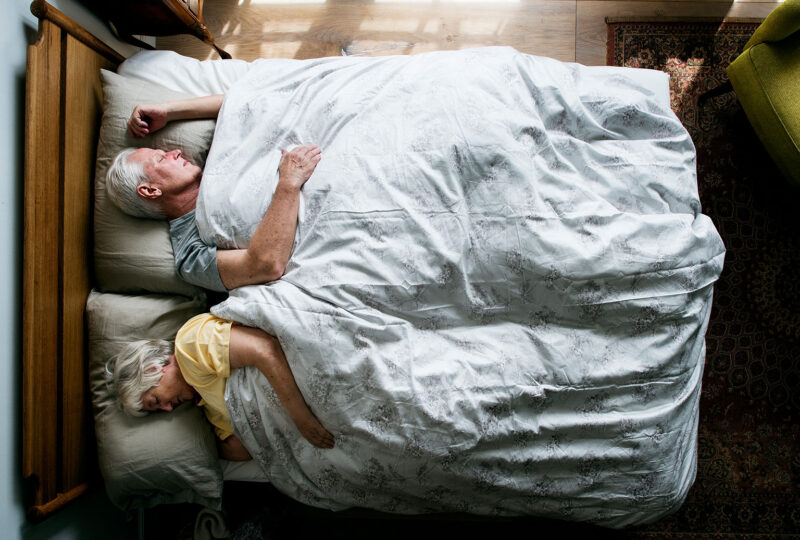 older couple sleeping in bed