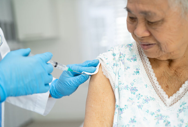senior woman about to get an injection vaccine flu shot