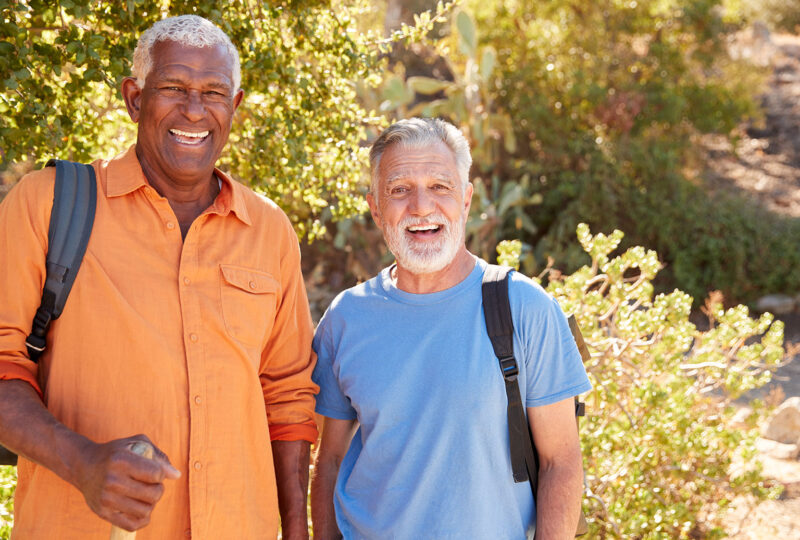two older men hiking in the woods
