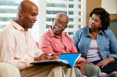 man talking to older adults about finances