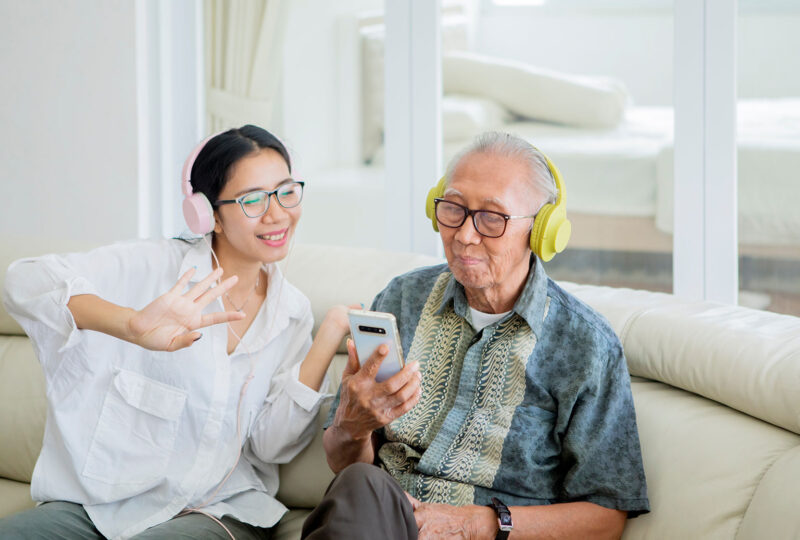 two people listening to music on an app with headphones