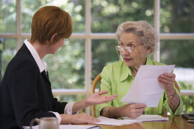 Senior woman talking to financial planner at home