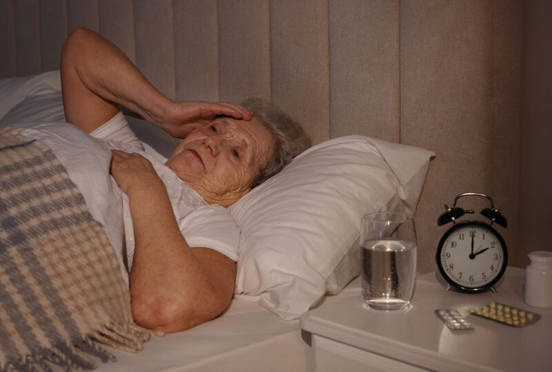 older woman awake in bed late at night