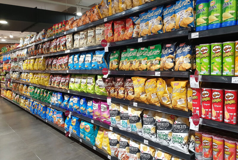 grocery store aisle containing chips and snacks