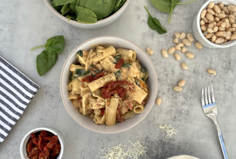 rigatoni in a dish with ingredients scattered around