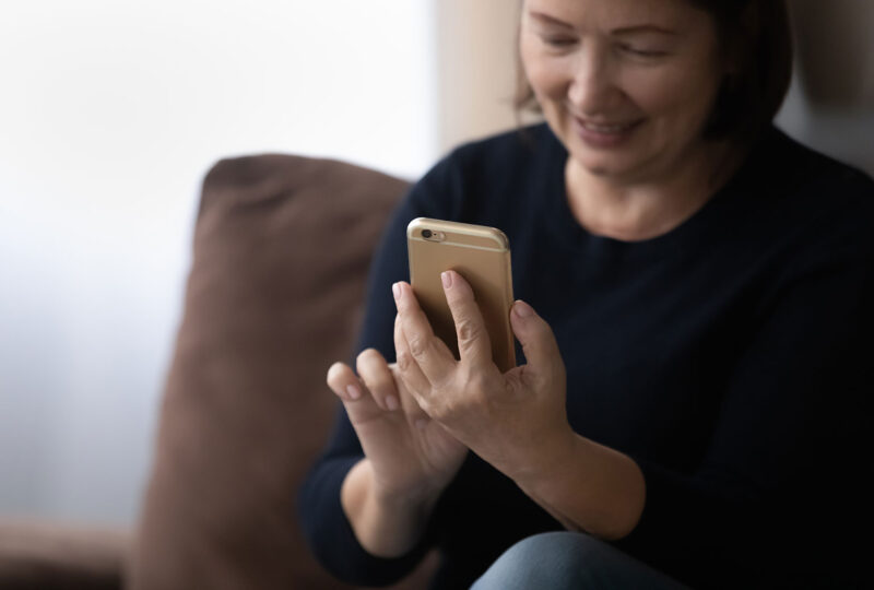 woman looking at smartphone in hand