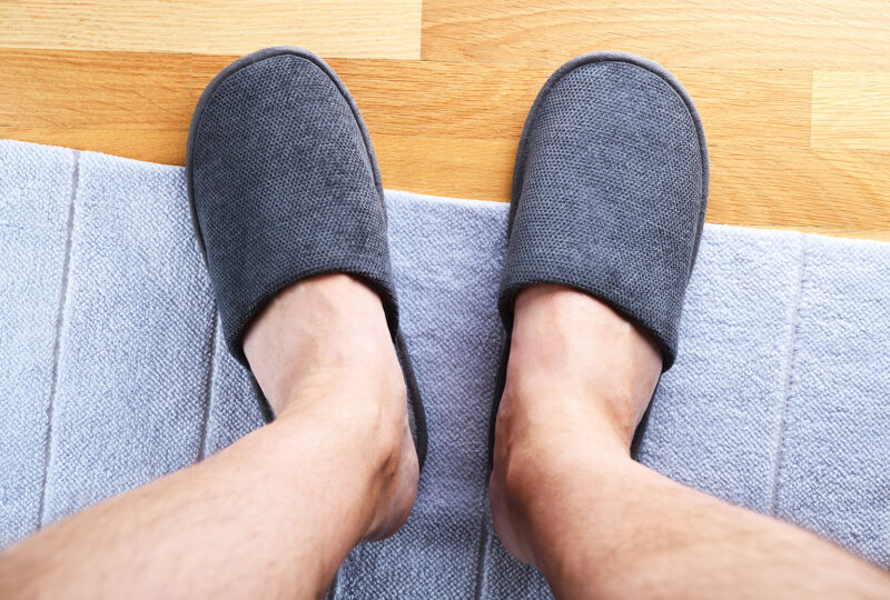looking down at feet in a pair of gray slippers