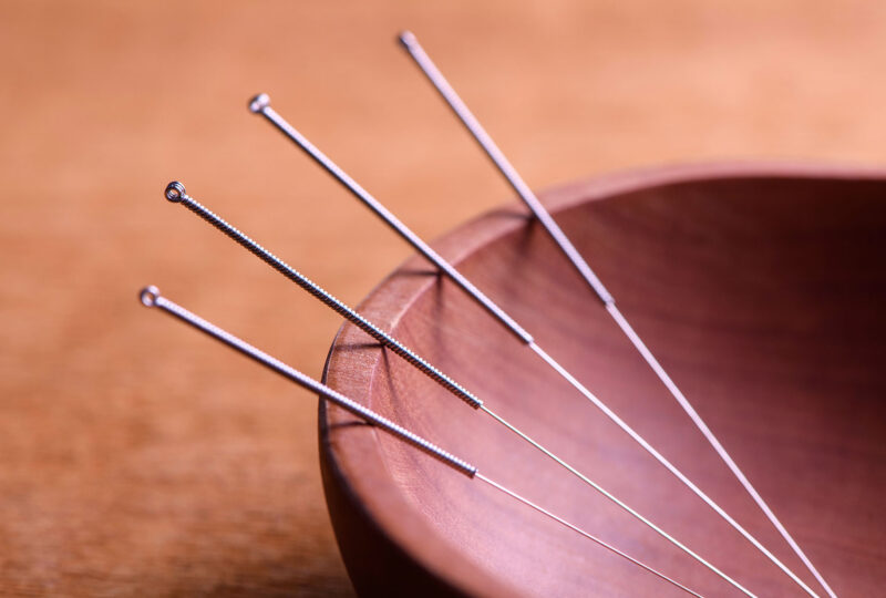 acupuncture needle in a wooden bowl