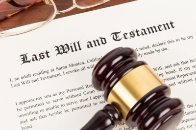 Last will and testament on yellowish paper with wooden judge gavel