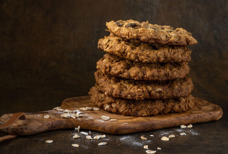 stack of oatmeal cookies on a wood cutting board