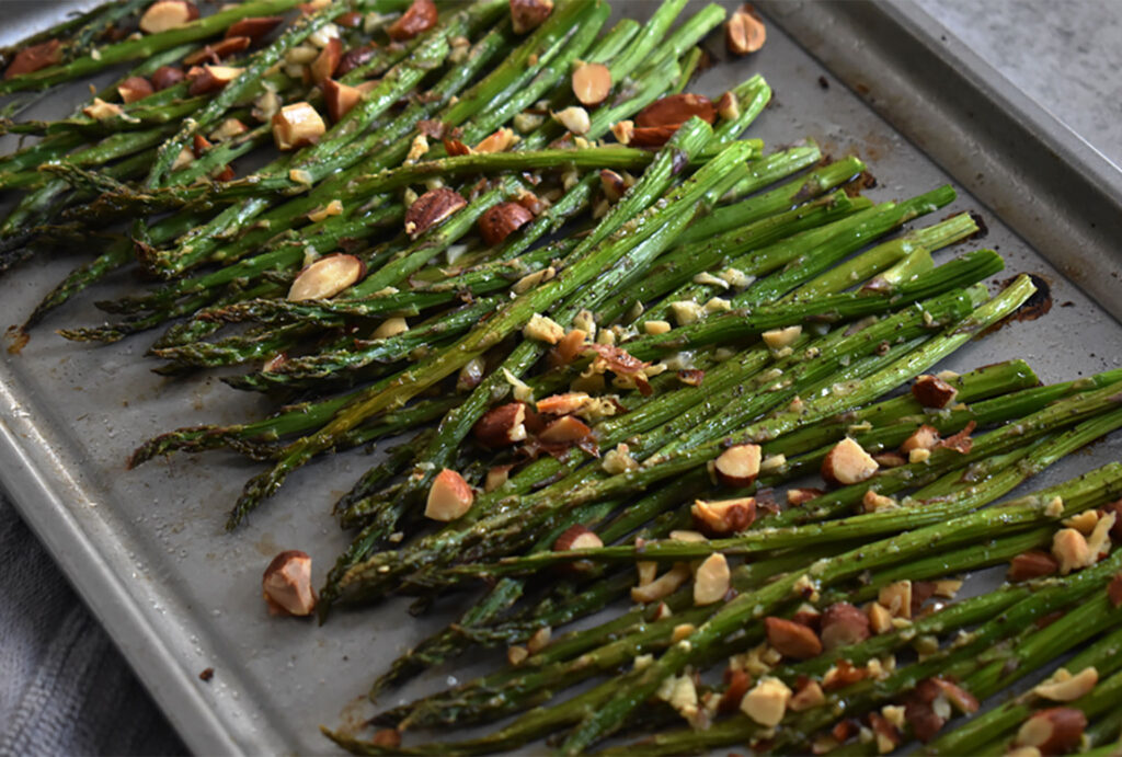 asparagus with almonds on a baking sheet