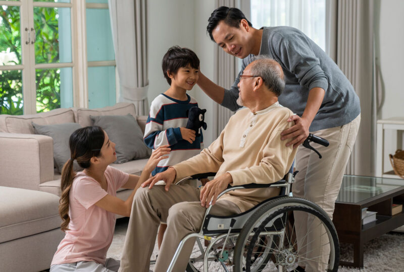 Young asian couple and child visiting grandparents in nursing home