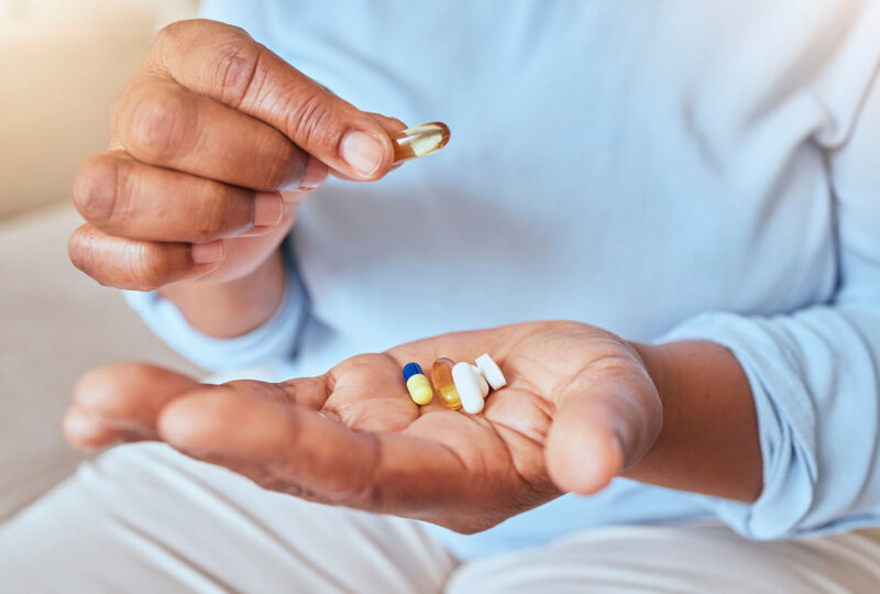 woman holding pills in her palm