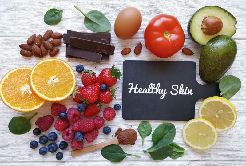Foods for healthy glowing skin. Assortment of various natural food products high in vitamins and minerals for skin health.