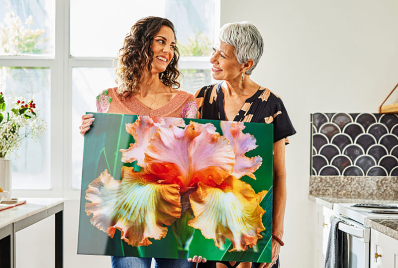 mother and daughter holding a picture of a flower