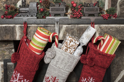 Stuffed stockings hanging on a fireplace on Christmas morning