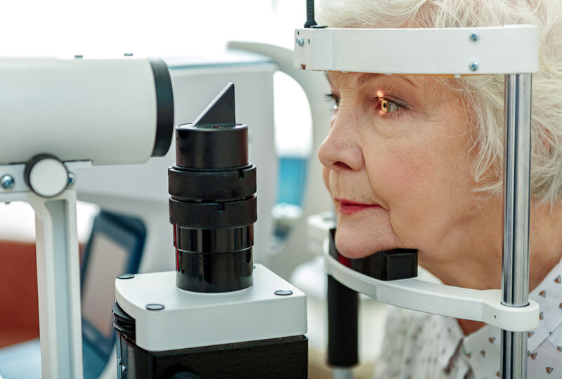 older woman being tested for cataracts at eye doctor