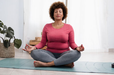 Woman doing pranayama breath exercises during yoga session at home