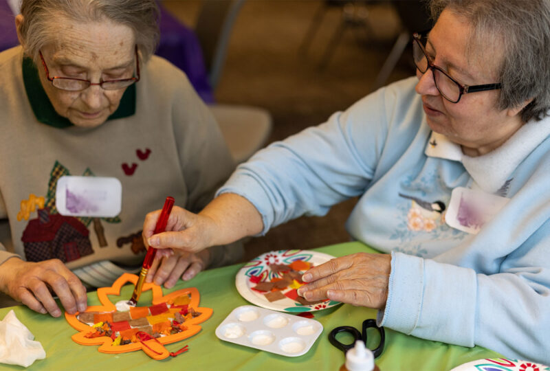 two older women working on a craft project